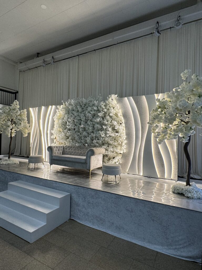 The Wave Garden weddingstage met golvende panelen en bloemenmuur